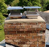 Newly repaired chimney crown and flue cap installation