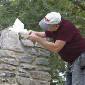 Gary Clift repairing stone chimney