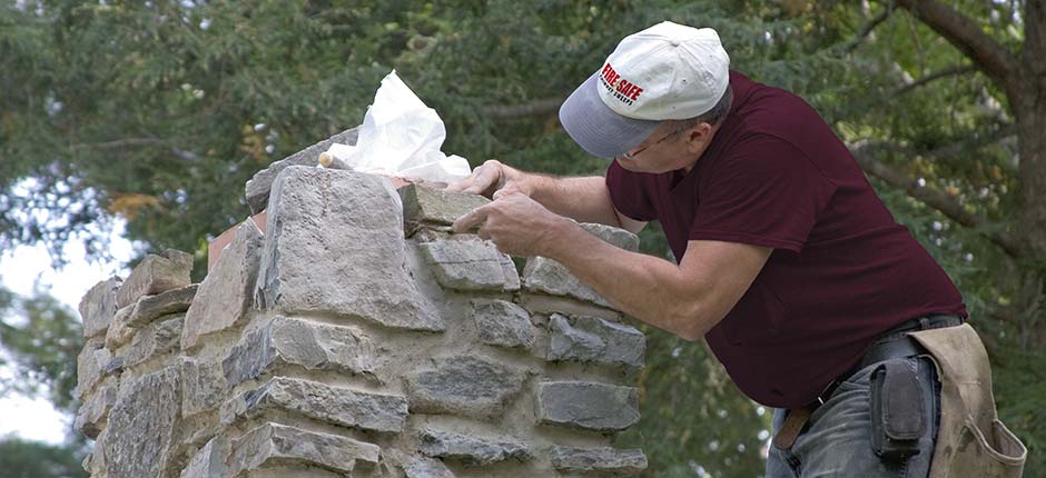 Gary Clift repairing stone masonry chimney